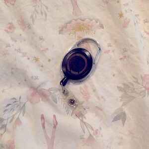 Two Retractable badge holders. one blue one black